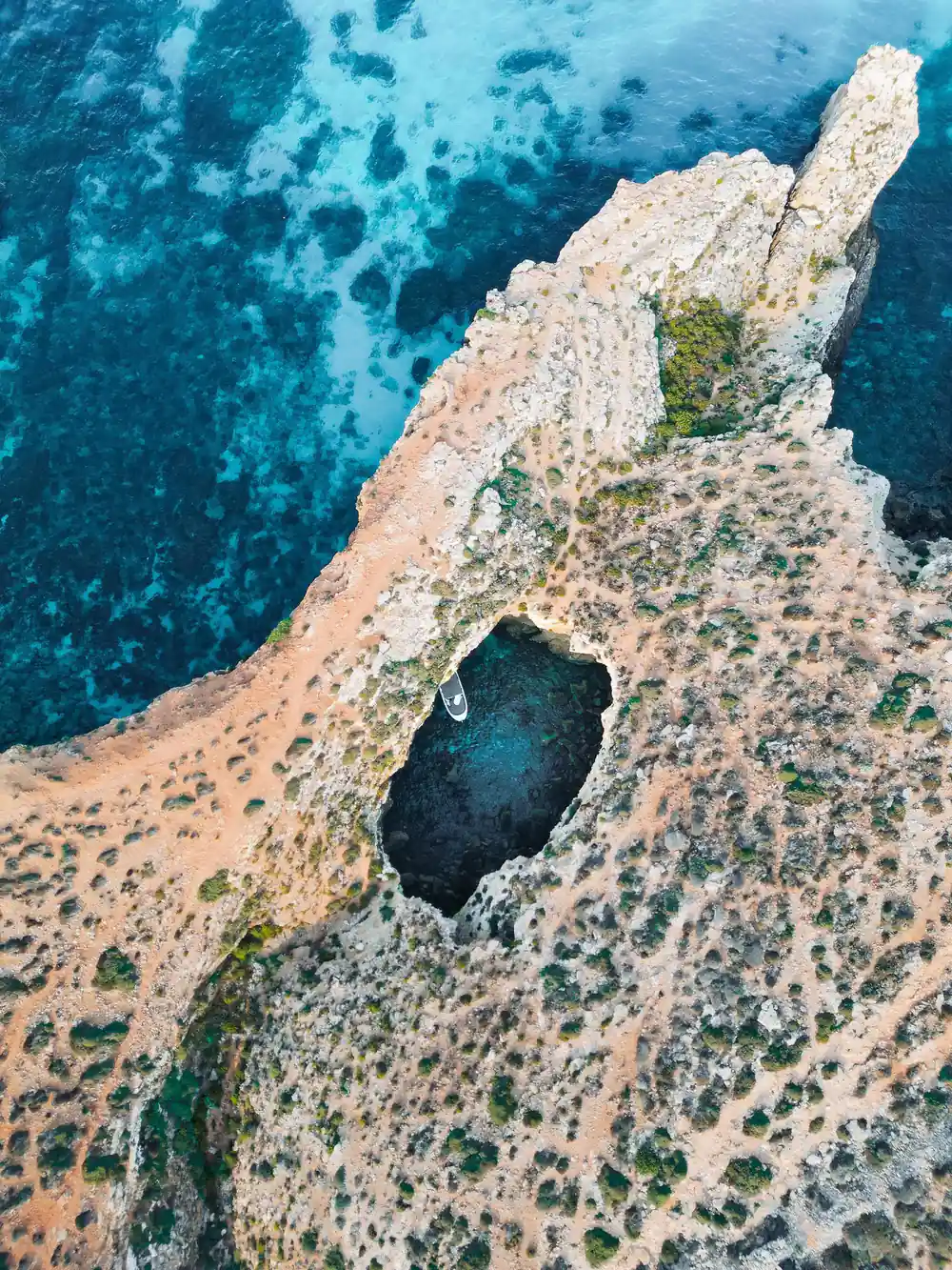 Aerial of a clifftop with a collapsed cave