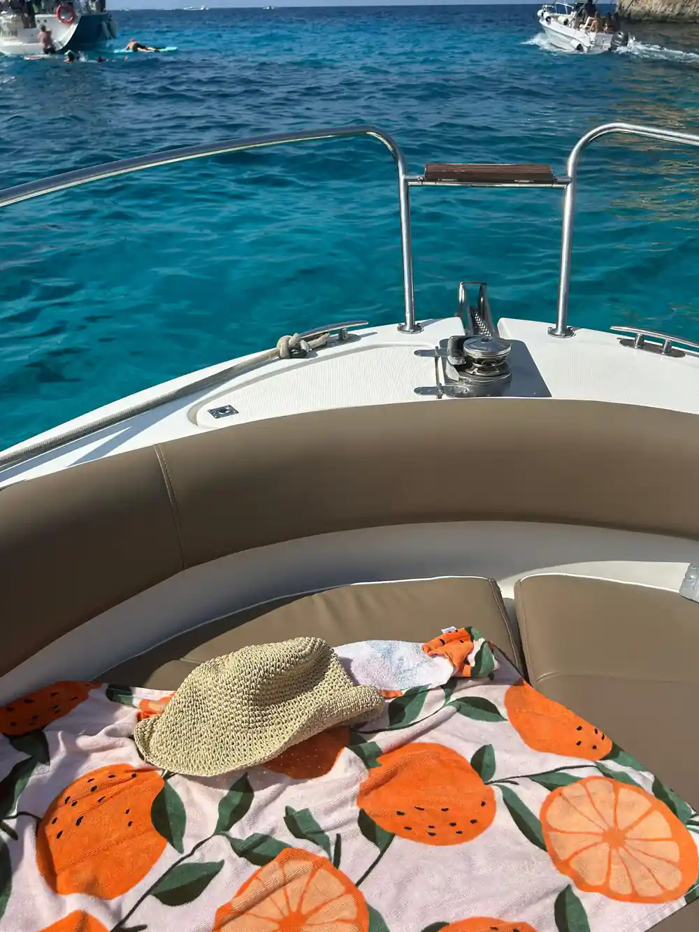 The boat's bow and a sunhat on the seat