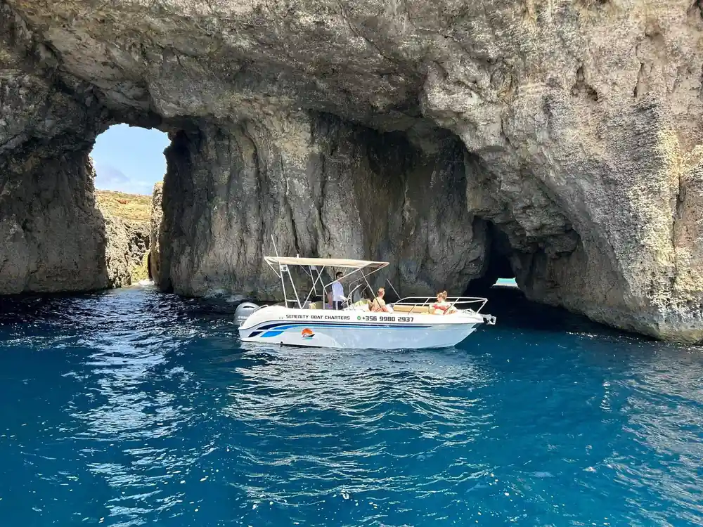 A boat at the mouth of a large cave