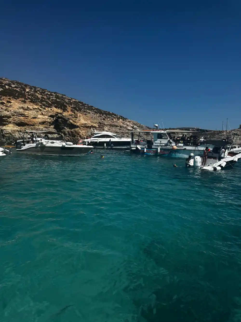 Boats moored along the shore in the lagoon