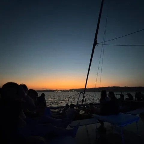A sailing catamaran at sunset off Malta
