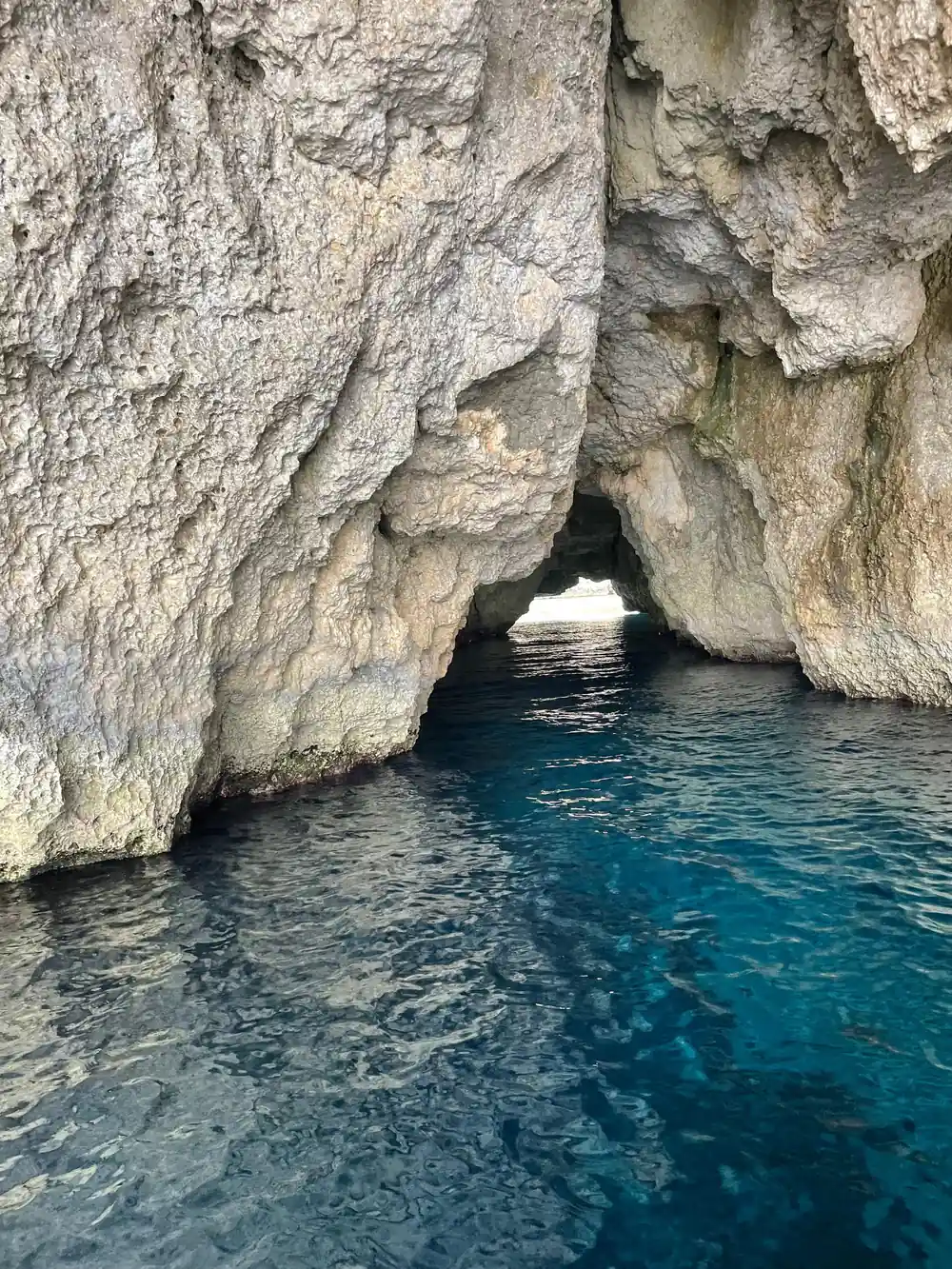 A cave arch with light through the far side