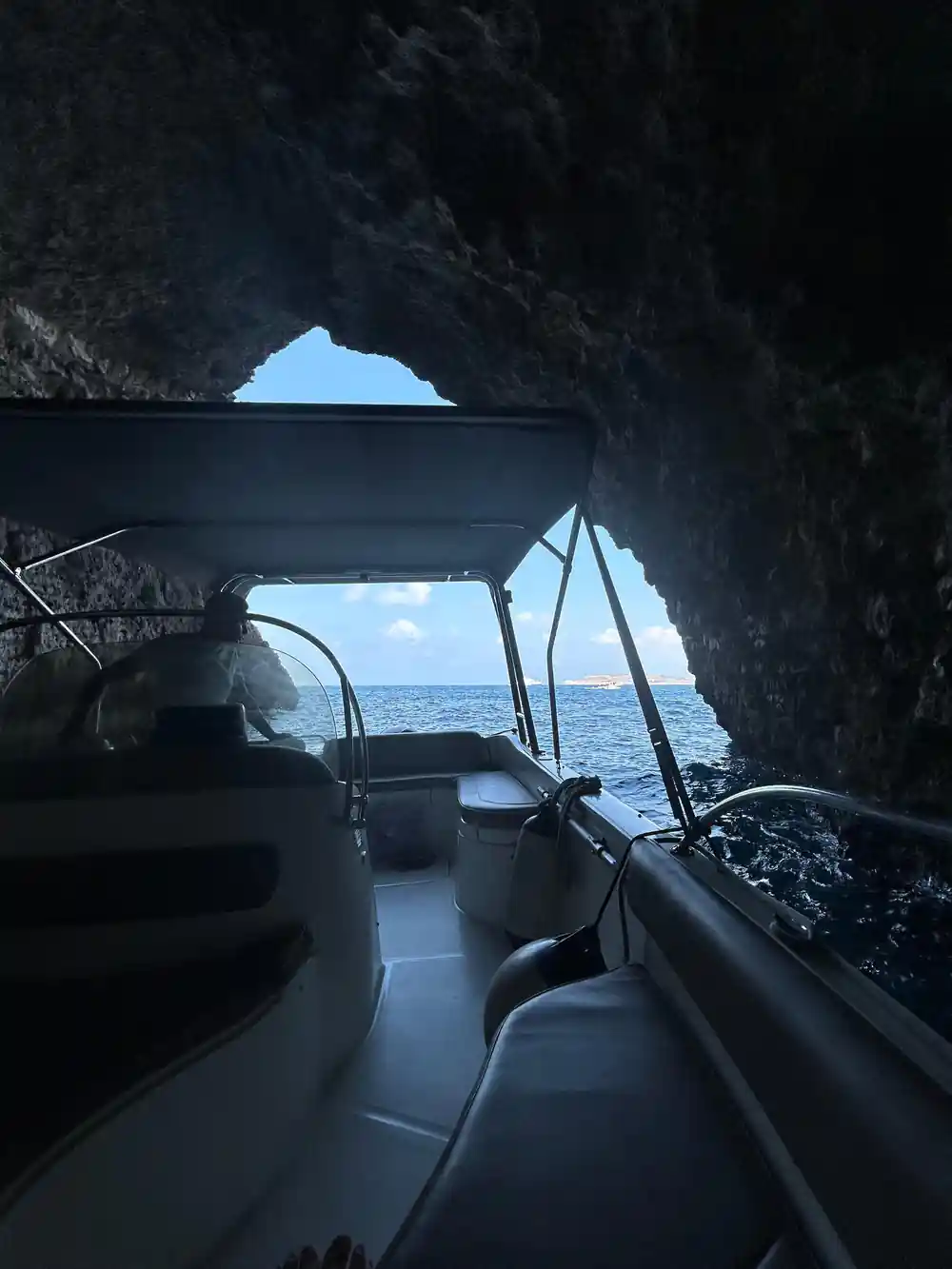 A cave mouth seen from under the boat's canopy
