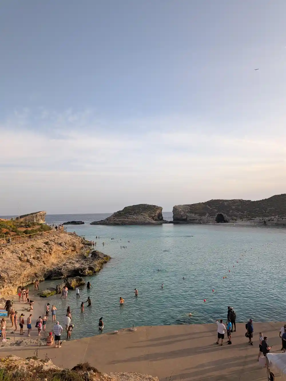 The lagoon beach with people on the rocks