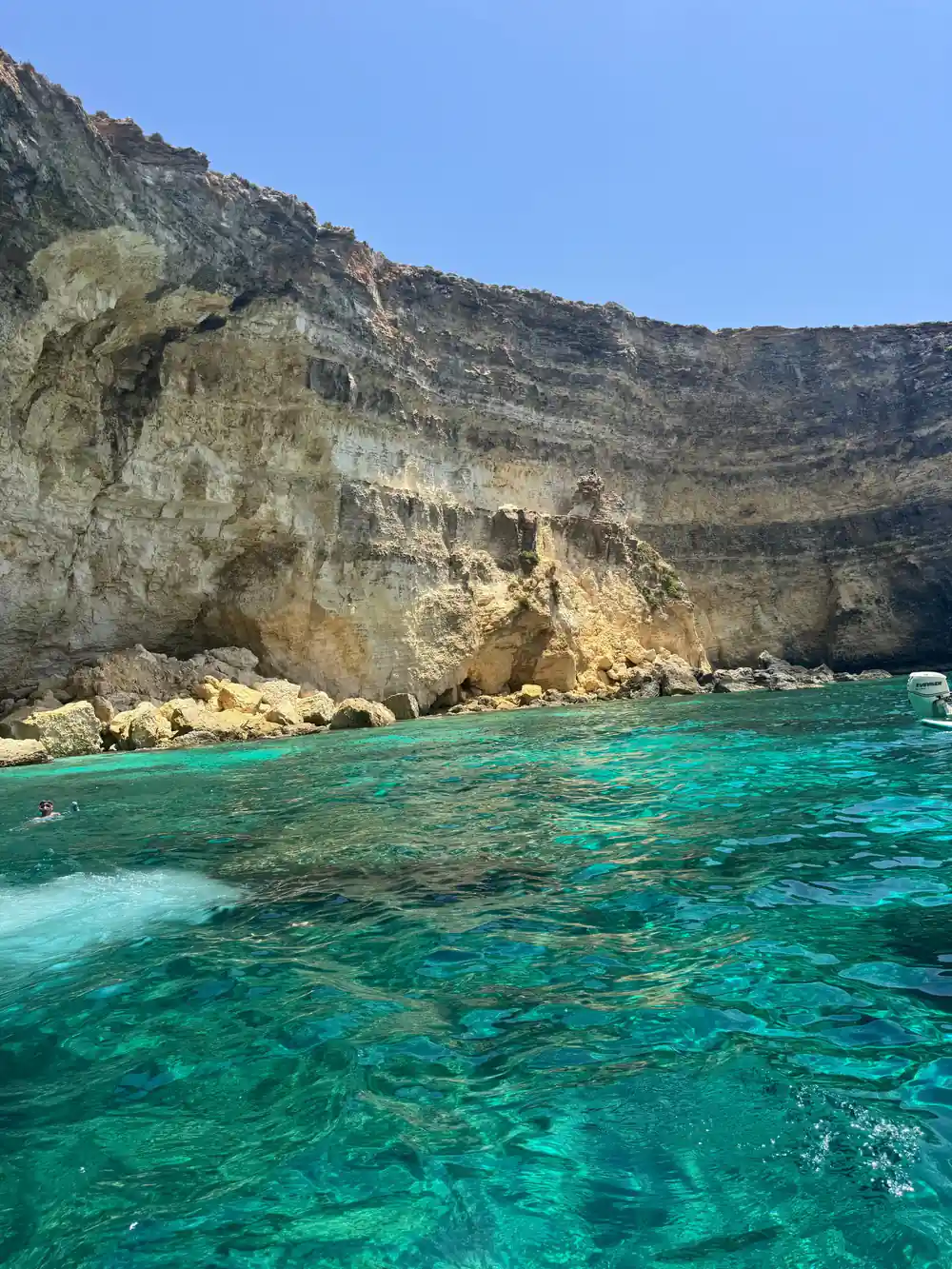 The long cliff wall above the lagoon