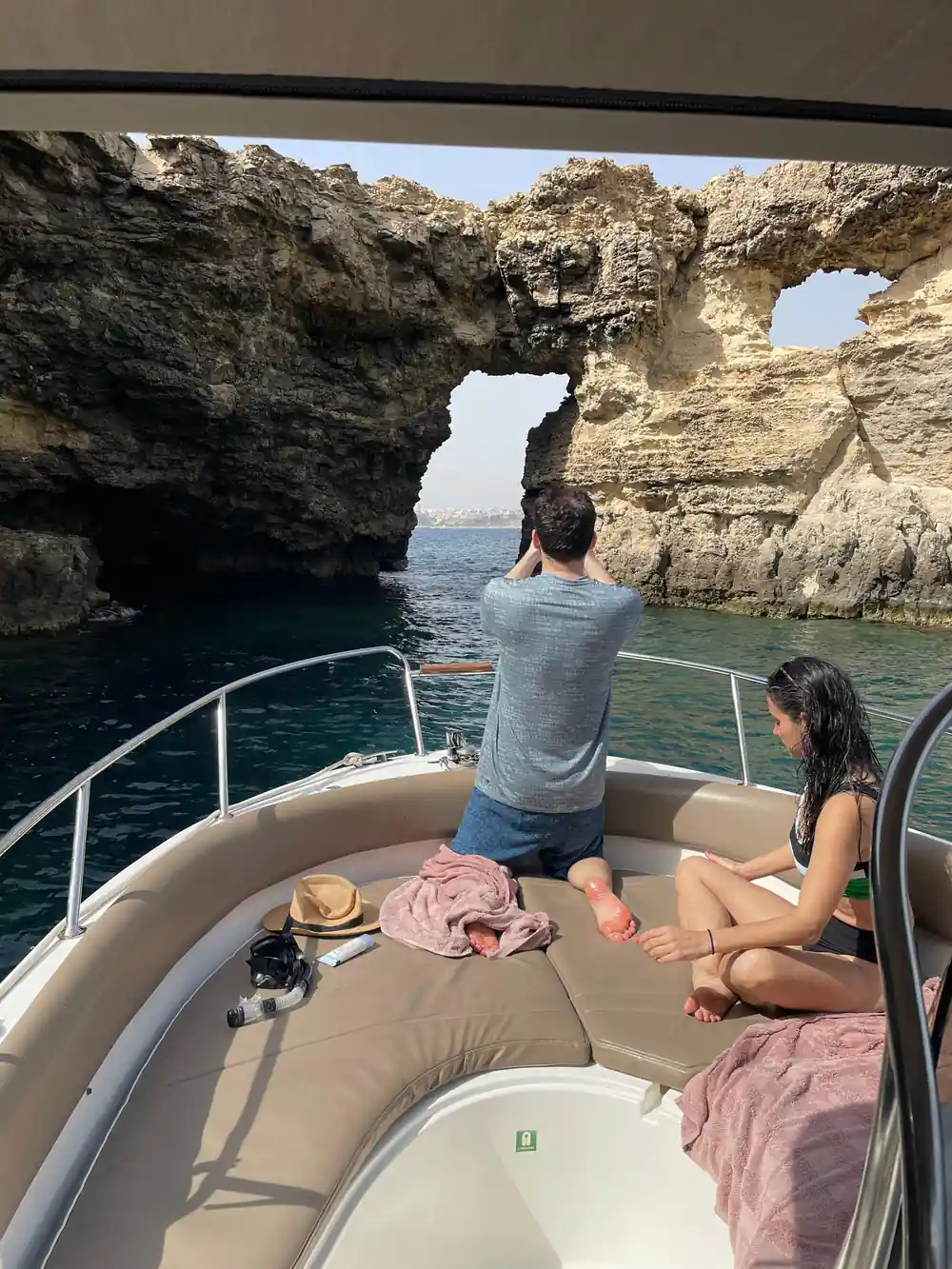 A passenger looking out at a rock arch