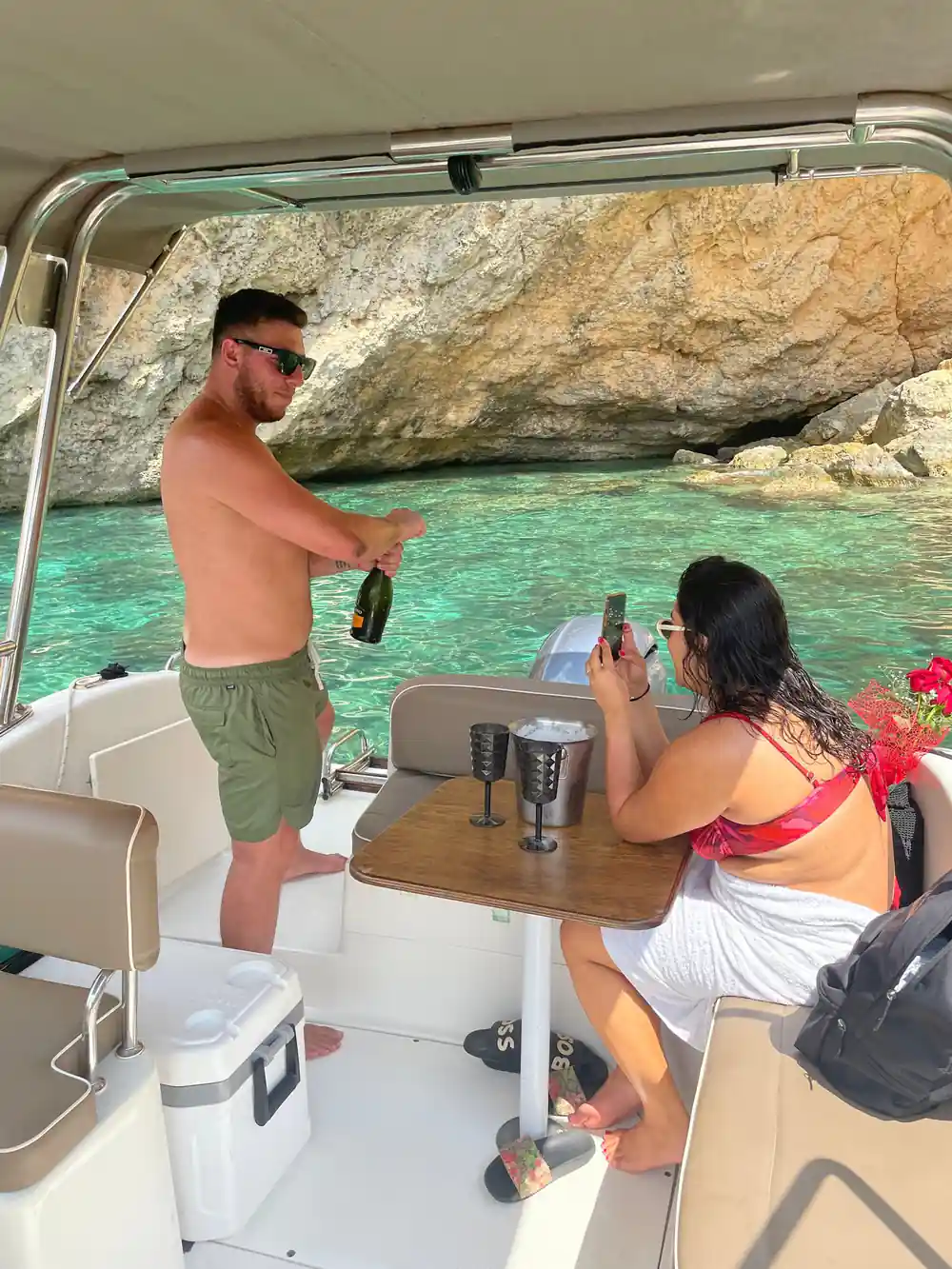 Passengers on the boat with a cliff behind