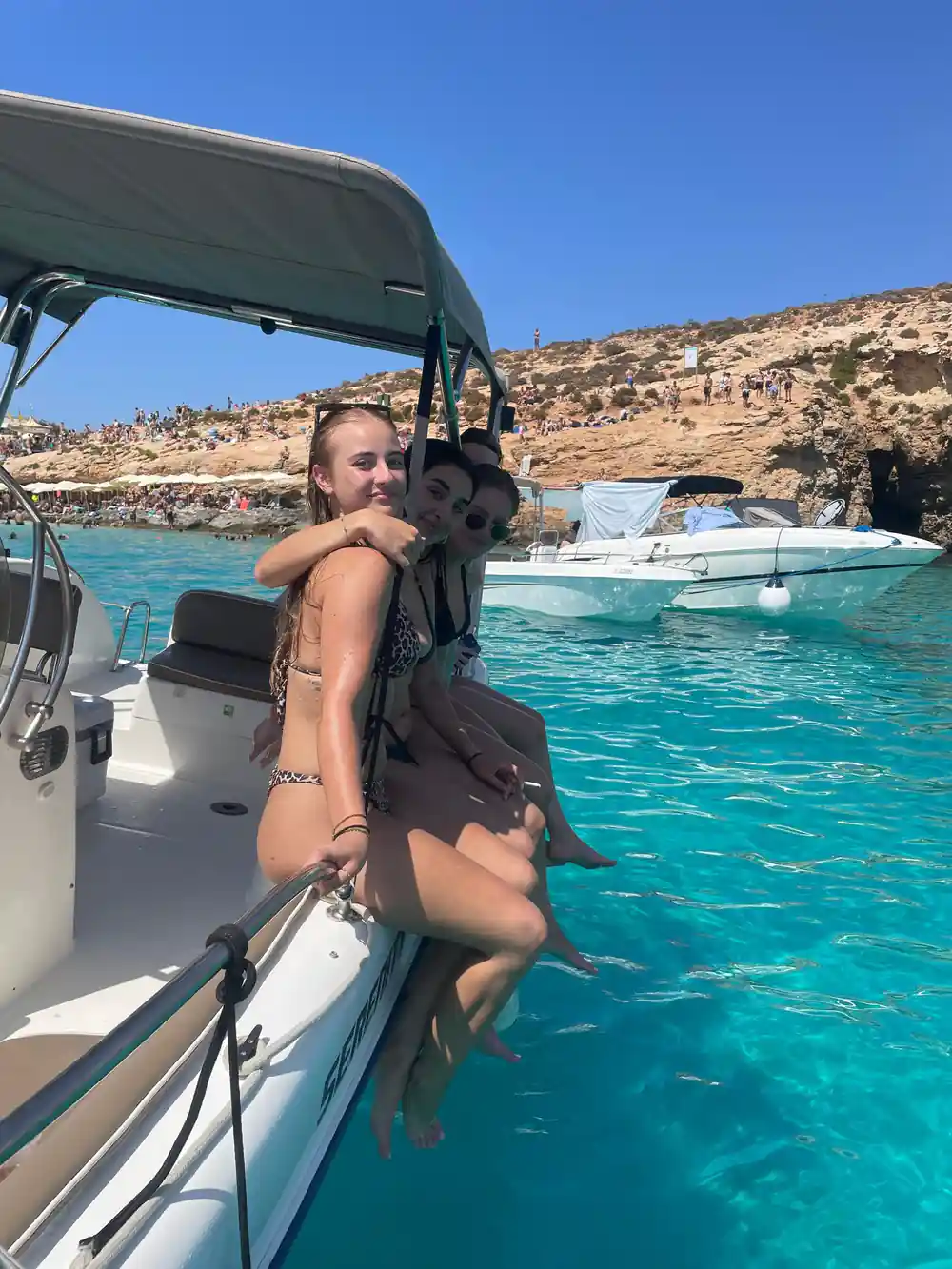 Passengers on the boat's side in the lagoon