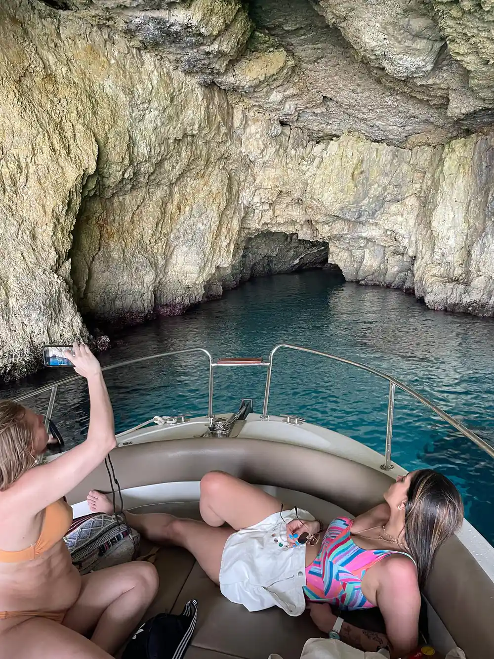 Passengers relaxing on the boat at a cave