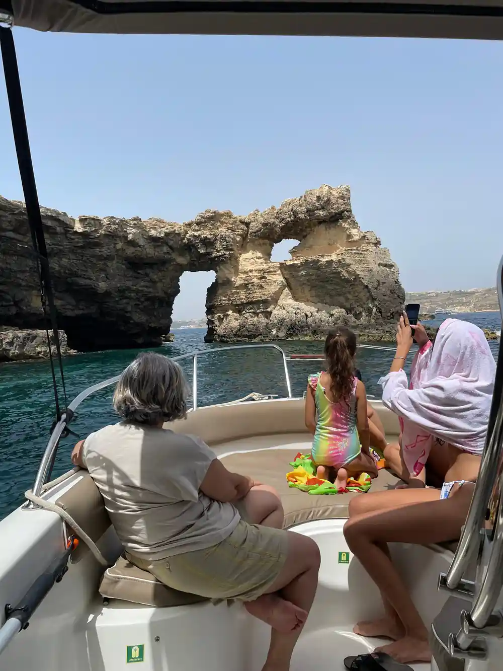 Passengers watching an arch from the boat