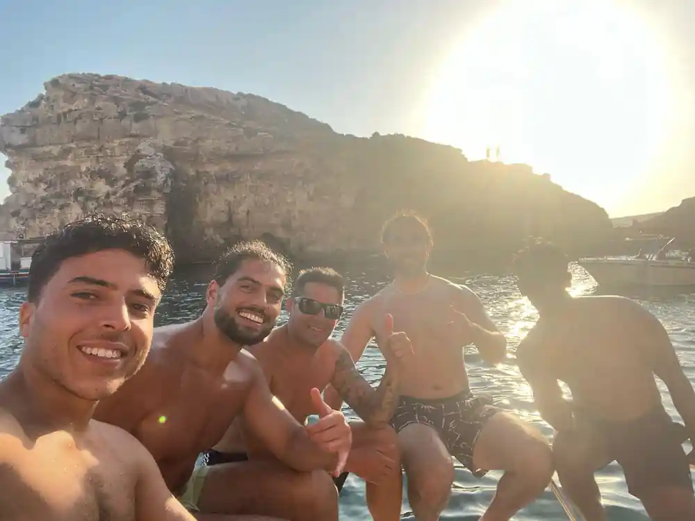 Passengers in the water beside the boat