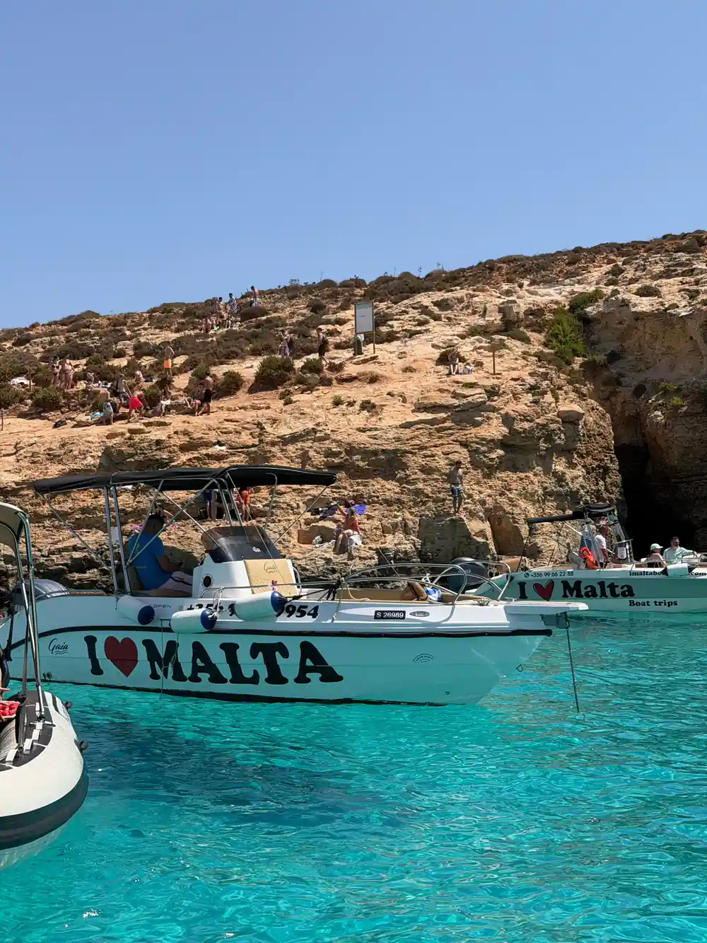 A tour boat moored below the cliff at the lagoon