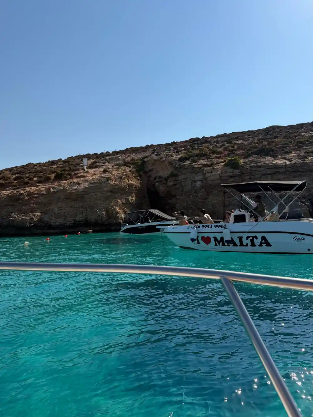 A tour boat moored at the cliff in the lagoon
