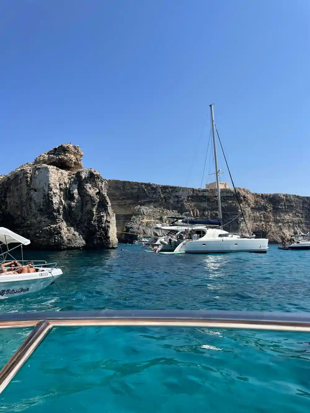 Yachts anchored below the cliff in the lagoon