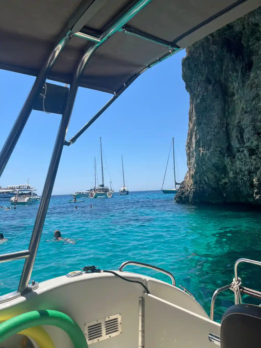 Yachts and swimmers in the channel seen from aboard